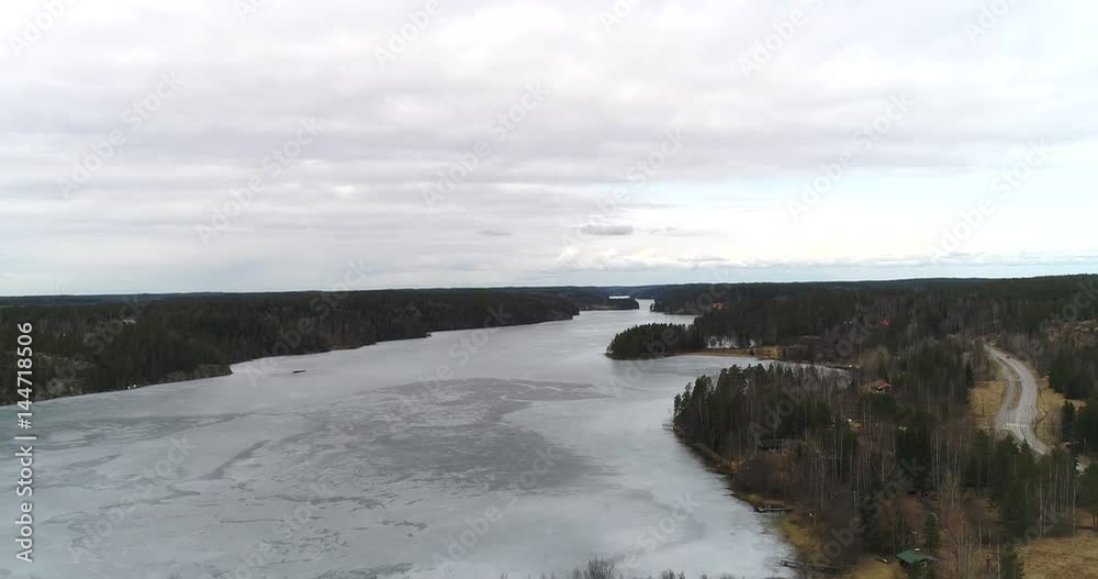 Nuuksion pitkajarvi, Cinema 4k landing aerial view of icy pitkajarvi lake, on a cloudy spring day, in nuuksio national park, in Espoo, Finland Nuuksion pitkajarvi, Cinema 4k landing aerial view of icy pitkajarvi lake, on a cloudy spring day, in nuuksio national park, in Espoo, Finland