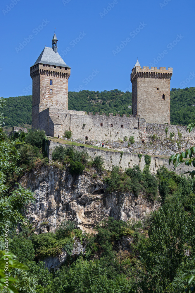 View on medieval castle growing from rocks with high walls and towers, Pyrenees, France