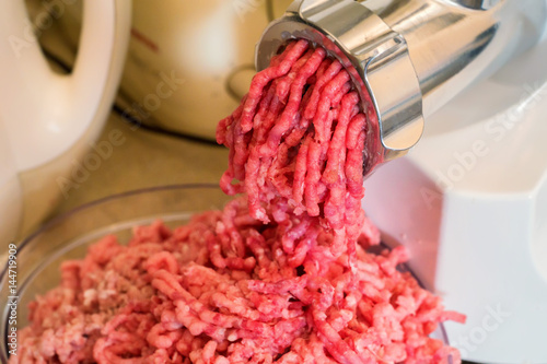 Close-up of minced meat coming out from grinder