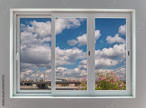 View of the Moscow city landscape through a triple window with sliding frames