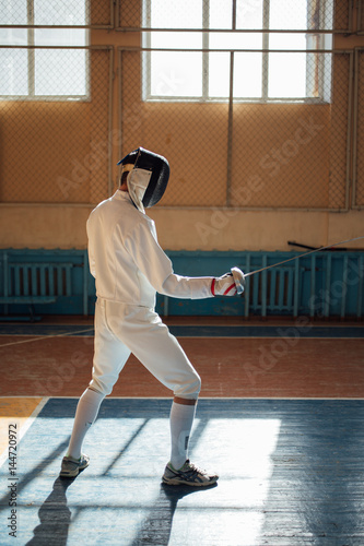 the fencer prepares for competitions. fencing coach. fencing sport motivation. mask and sword
