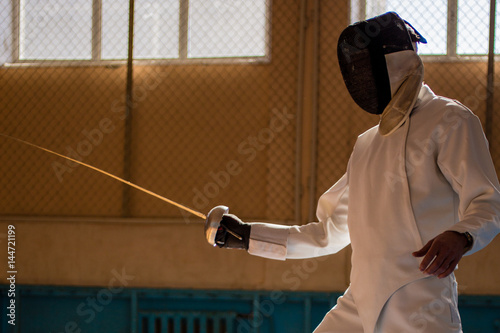 the fencer prepares for competitions. fencing coach. fencing sport motivation. mask and sword