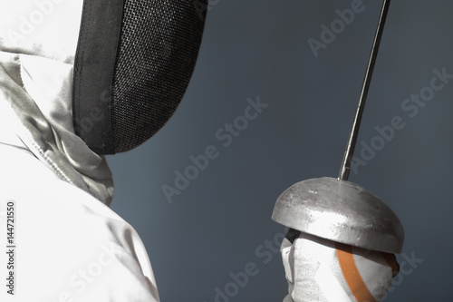 the fencer prepares for competitions. fencing coach. fencing sport motivation. mask and sword