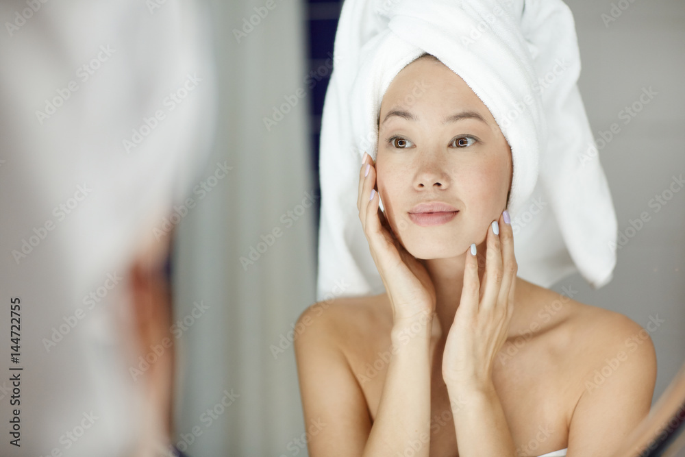 Woman with perfect skin looking in mirror Woman with perfect skin looking in mirror