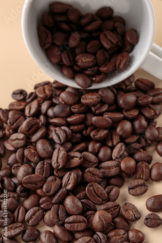 Coffee beans and white cup of coffee