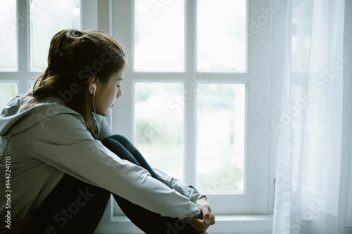 Free Download Lonely Asia young woman listening to music during workout at home - GFXLoad