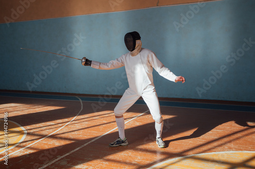 the fencer prepares for competitions. fencing coach. fencing sport motivation. mask and sword