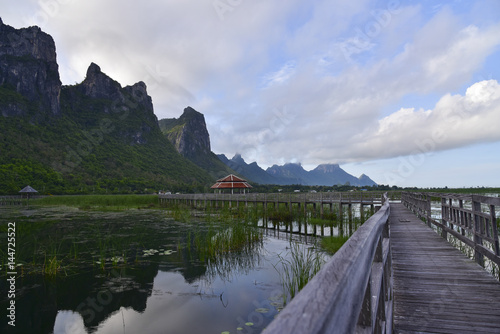 Old wooden bridge path to pavilion on lagoon. Beautiful tourist attractions,Thailand 