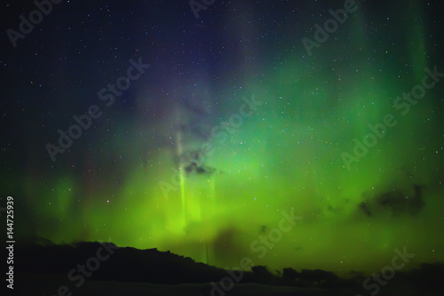 Northern lights. Aurora borealis nature landscape at night © Ivan Kurmyshov
