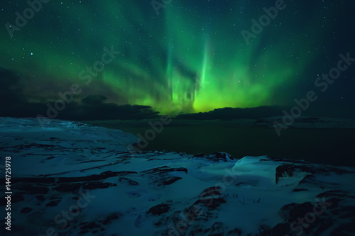 Northern lights. Aurora borealis nature landscape at night © Ivan Kurmyshov