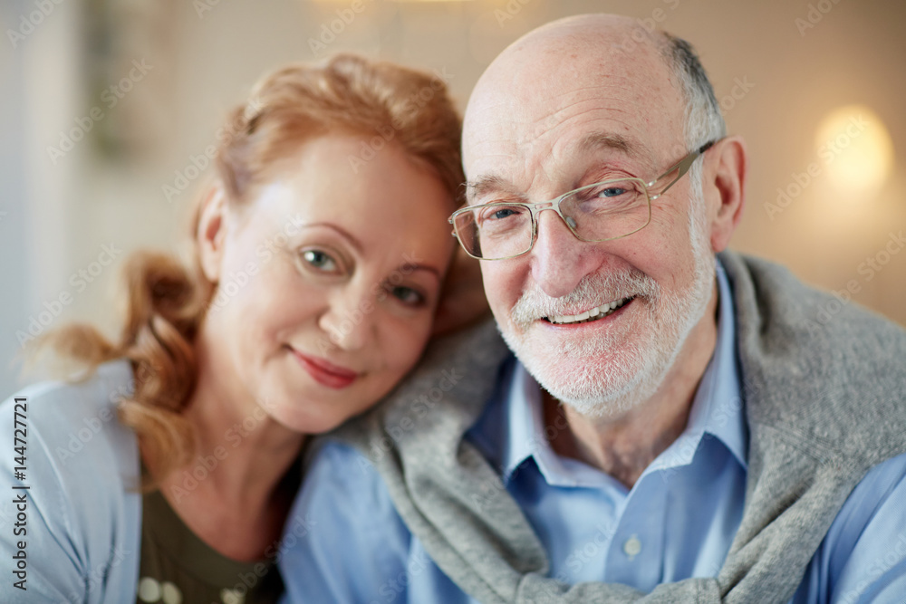 Senior affectionate couple looking at camera Senior affectionate couple looking at camera
