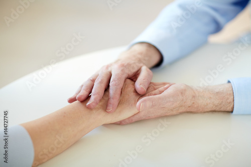 Hands of retired husband and wife