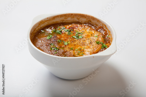 French onion soup in a deep white bowl. photo