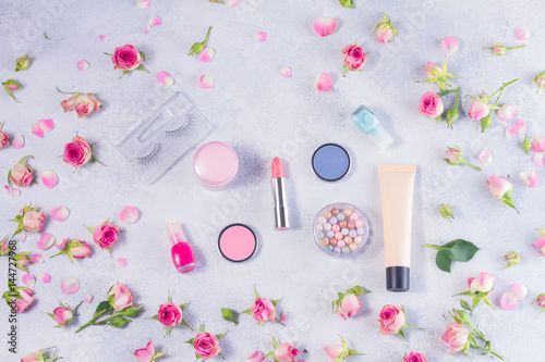Colorful make up and roses top view flat lay scene