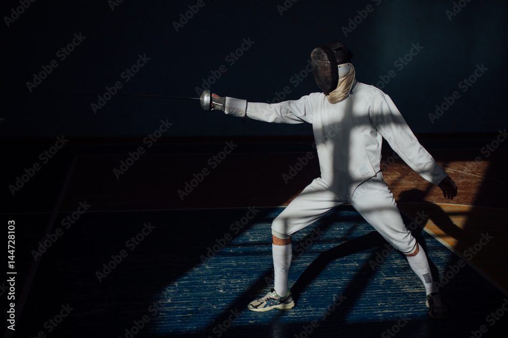 the fencer prepares for competitions. fencing coach. fencing sport motivation. mask and sword