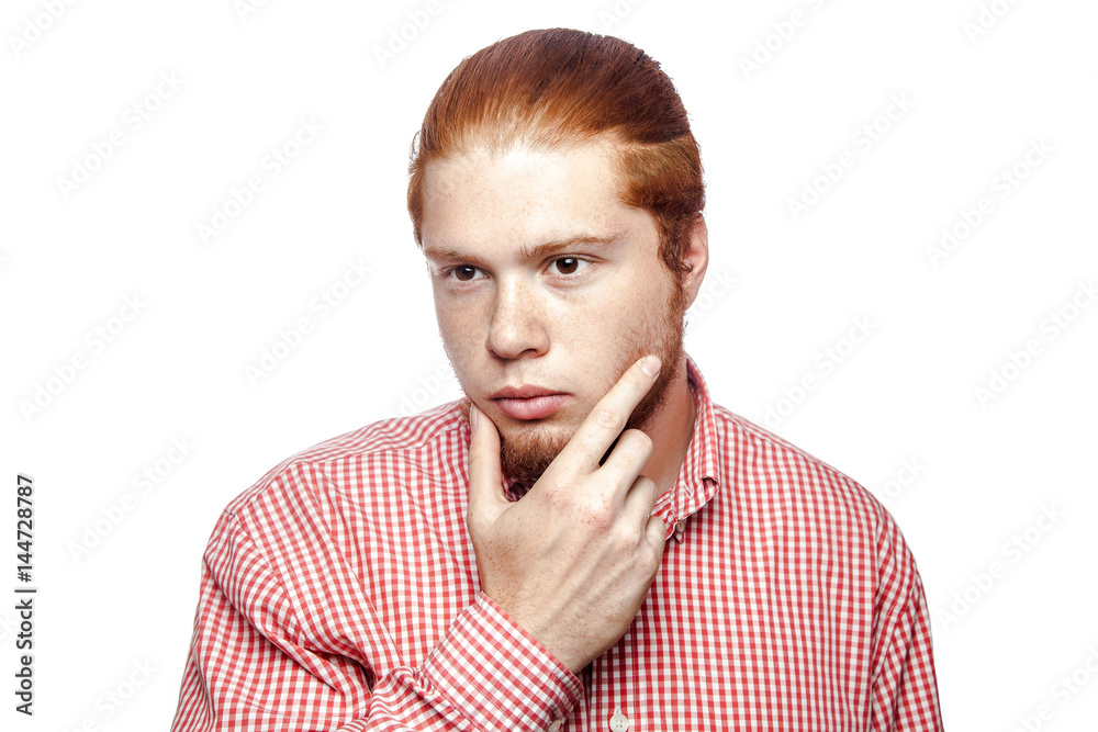 thoughtful thinking bearded readhead businessman with red shirt and freckles side looking. studio shot isolated on white. thoughtful thinking bearded readhead businessman with red shirt and freckles side looking. studio shot isolated on white.