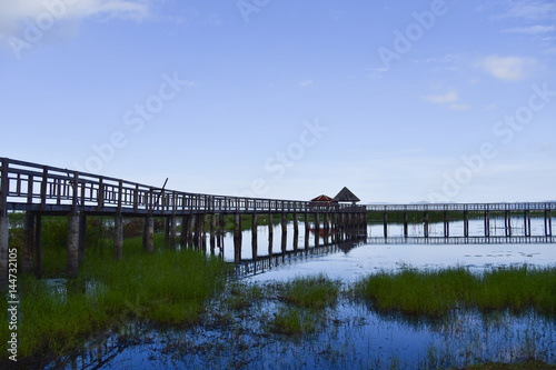 The pavilion and old wooden bridge path on lagoon. Beautiful tourist attractions Thailand  