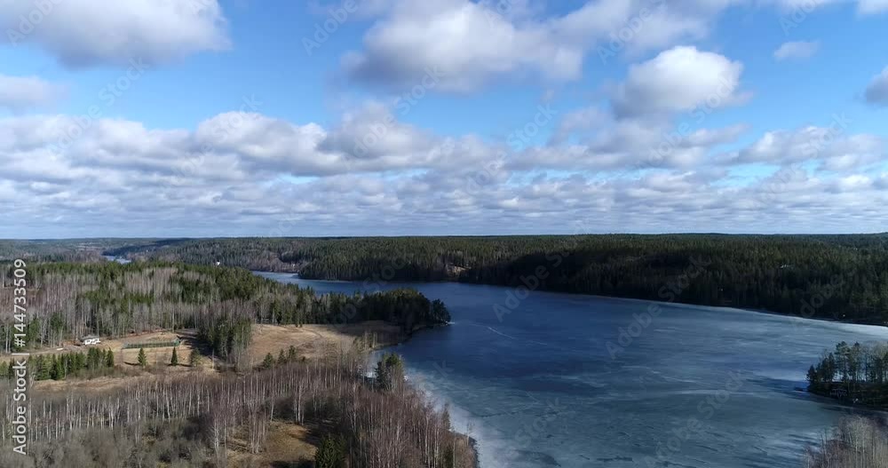 Nuuksion pitkajarvi, Cinema 4k landing aerial view of icy pitkajarvi lake, on a sunny spring day, in nuuksio national park, in Espoo, Finland Nuuksion pitkajarvi, Cinema 4k landing aerial view of icy pitkajarvi lake, on a sunny spring day, in nuuksio national park, in Espoo, Finland