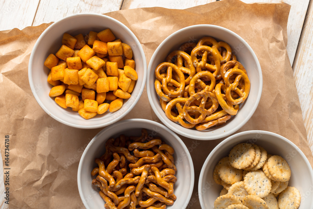 Pretzels in bowls on wooden table from above