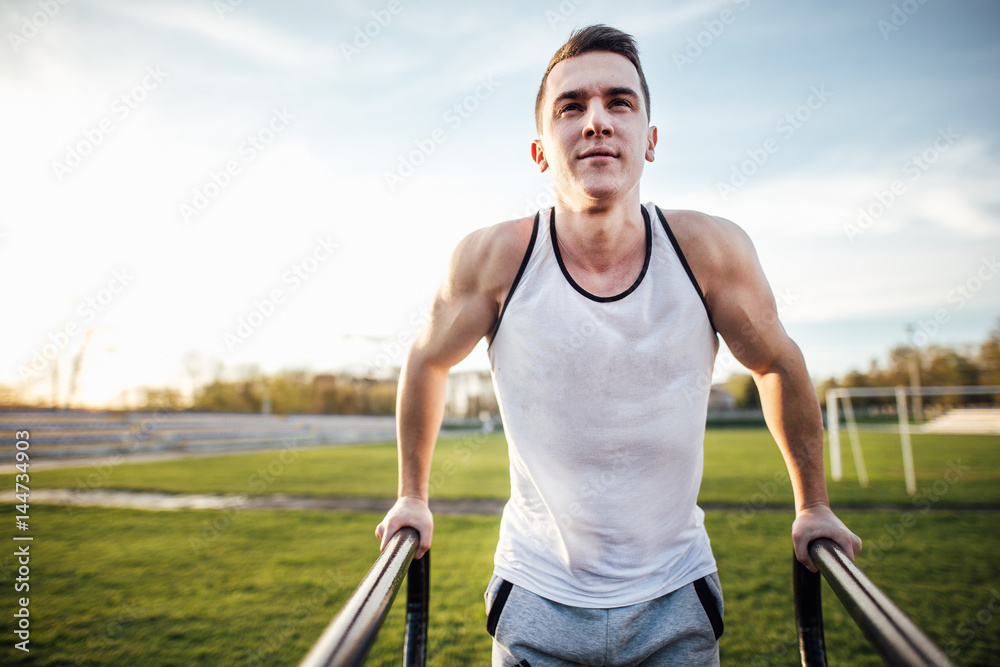 Man do workout at stadium area with sunshine background