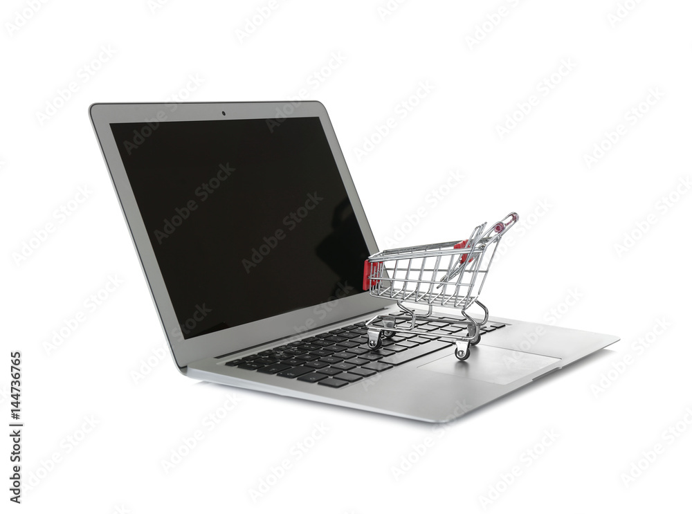 Online shopping concept. Laptop with mini market trolley on white background