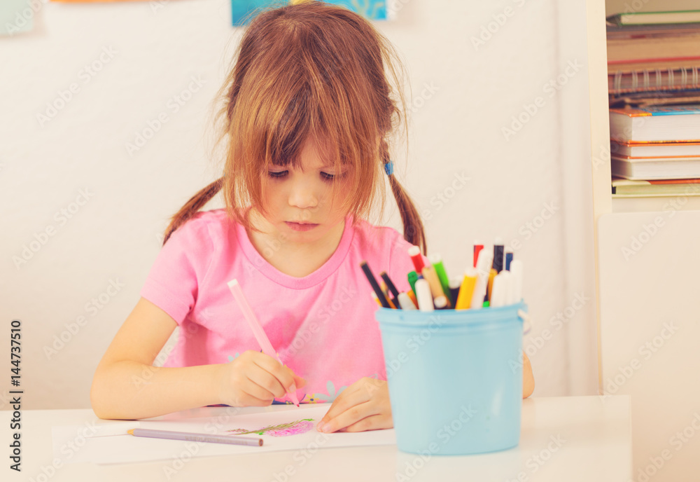 Small girl drawing with colourful pencils Small girl drawing with colourful pencils