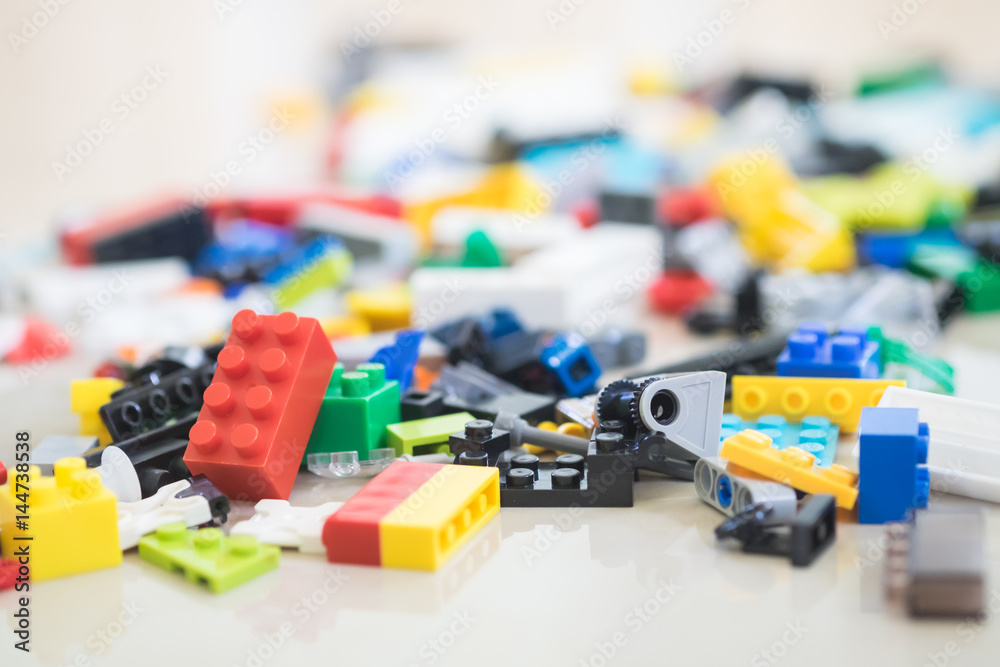 Obraz premium Missing piece of jigsaw puzzle among the pile of plastic blocks