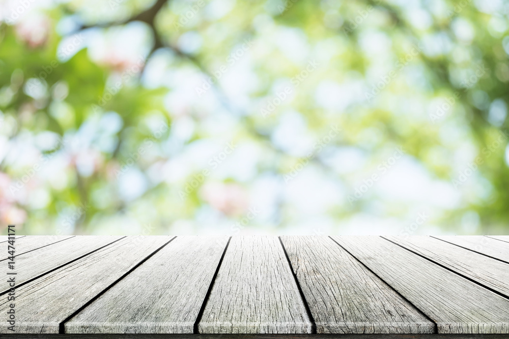 Empty wooden table with party in garden background blurred.