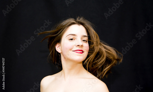 Portrait of Beautiful Young Woman Shaking Her Hair