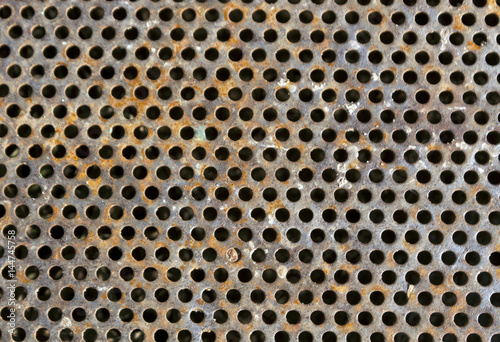 Rusty color perforated metal floor pattern.