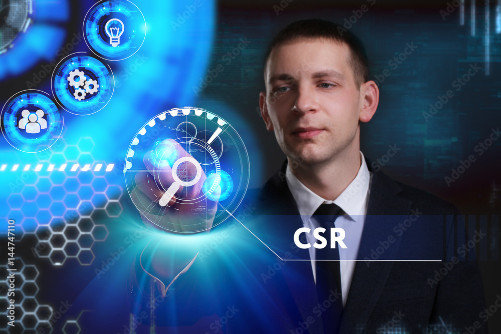 Business, Technology, Internet and network concept. Young businessman working on a virtual screen of the future and sees the inscription: CSR Business, Technology, Internet and network concept. Young businessman working on a virtual screen of the future and sees the inscription: CSR