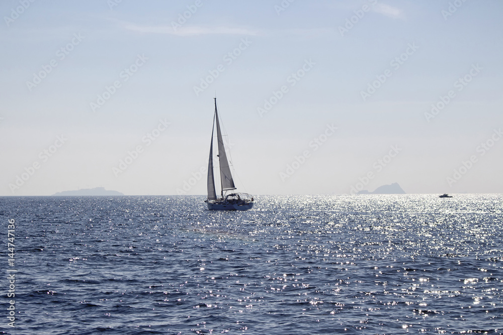 View of sailing boat near Istanbul. Sun light shines on Marmara sea surface.