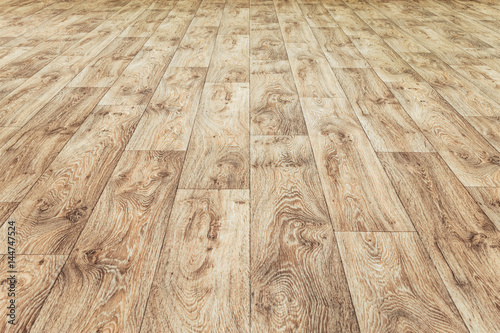 Linoleum flooring with embossed wood texture. Brown floor large area. Horizontal layout perspective. photo