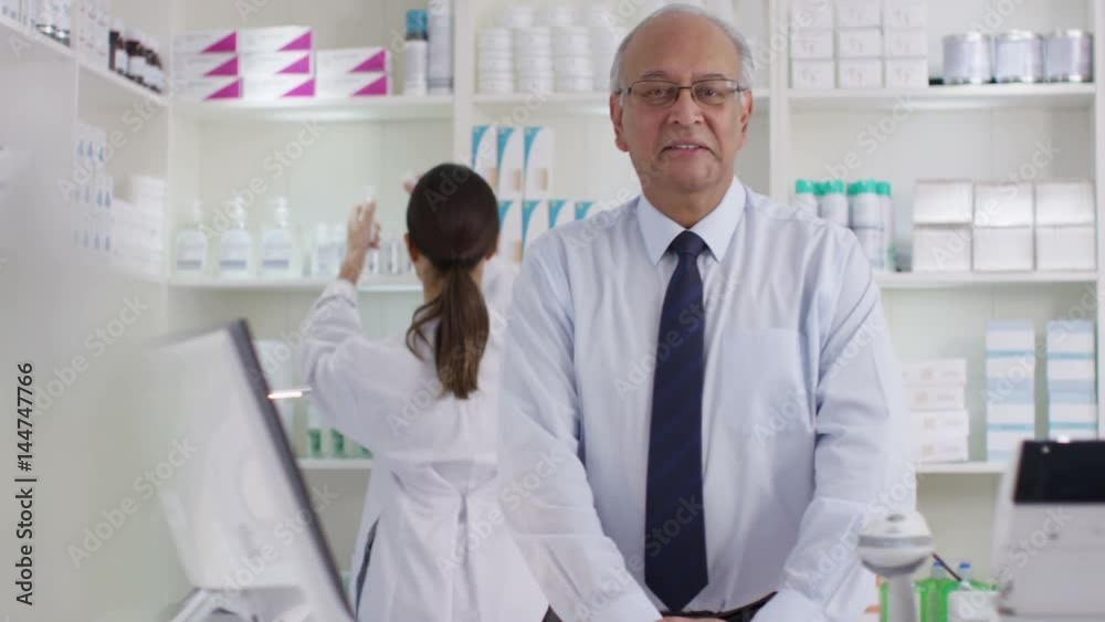  Portrait of friendly smiling worker in a chemist shop