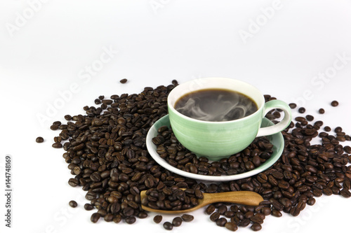 cup of coffee and and coffee beans with smoke on isolated white background