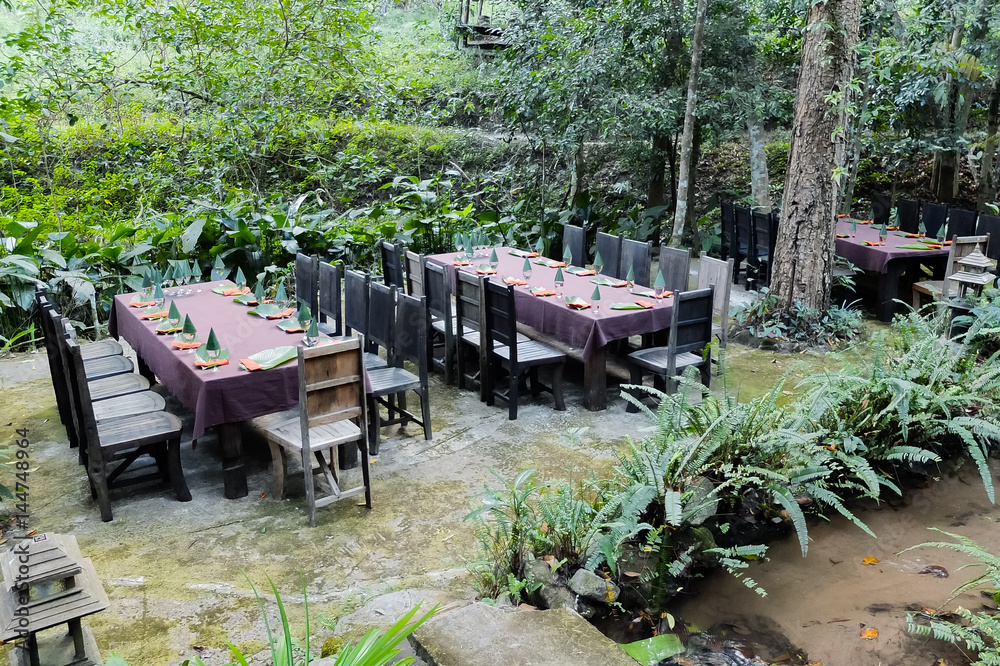 Outdoor tables setting with natural material in the garden Outdoor tables setting with natural material in the garden