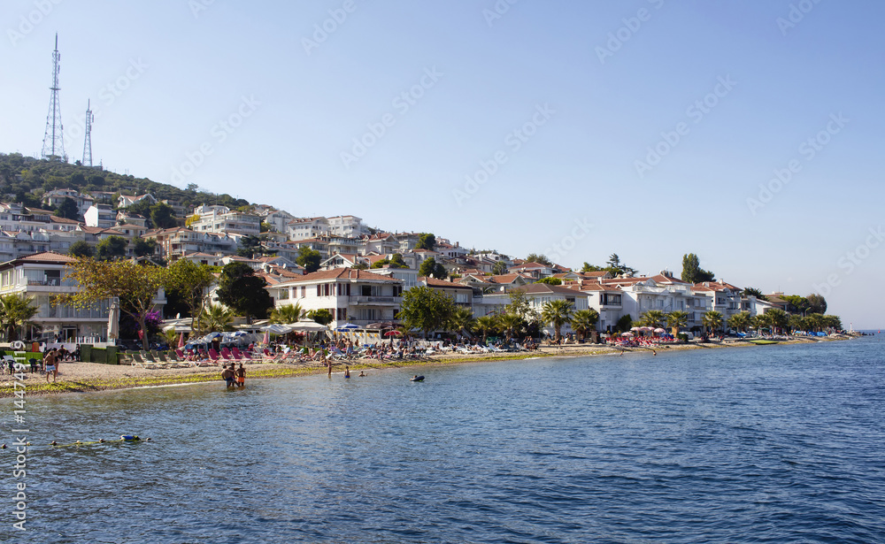 View of beach in Kinaliada which is one of Prince Islands also known as Adalar in Istanbul. Summer houses and people taking sun bath are in the view. It is the closest one to Istanbul
