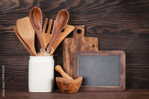Kitchen utensils and chalkboard