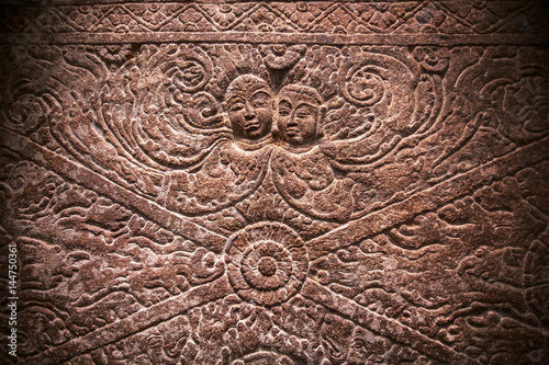 Magic two ghost on carved wall relief inside the 6th century temples in Aihole, India. Ancient Indian artwork.