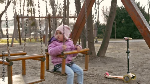 Little girl on swings