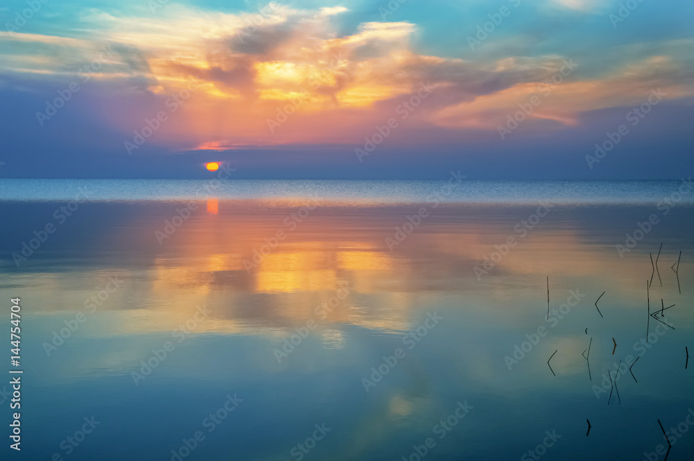 sunrise with reflection on water