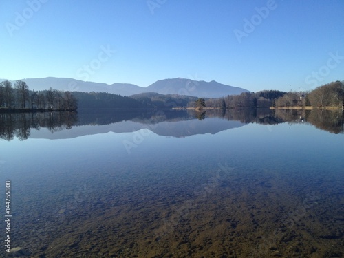Impressing lake view with perfekt reflection of landscape in the Staffelsee near Murnau in Germany