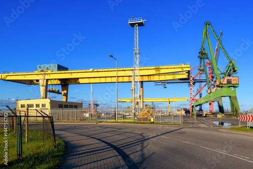 Yellow gantry cranes and green crane in the port of Gdansk. Poland.