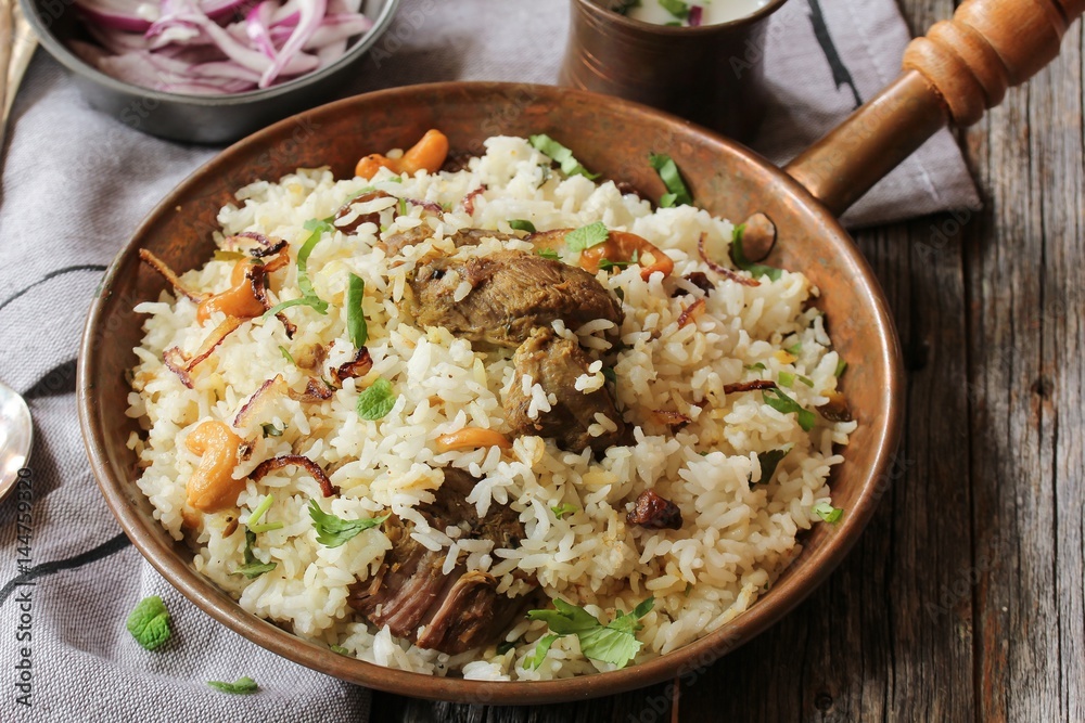 Kerala Malabar Mutton Biryani served with yogurt dip, selective focus Kerala Malabar Mutton Biryani served with yogurt dip, selective focus
