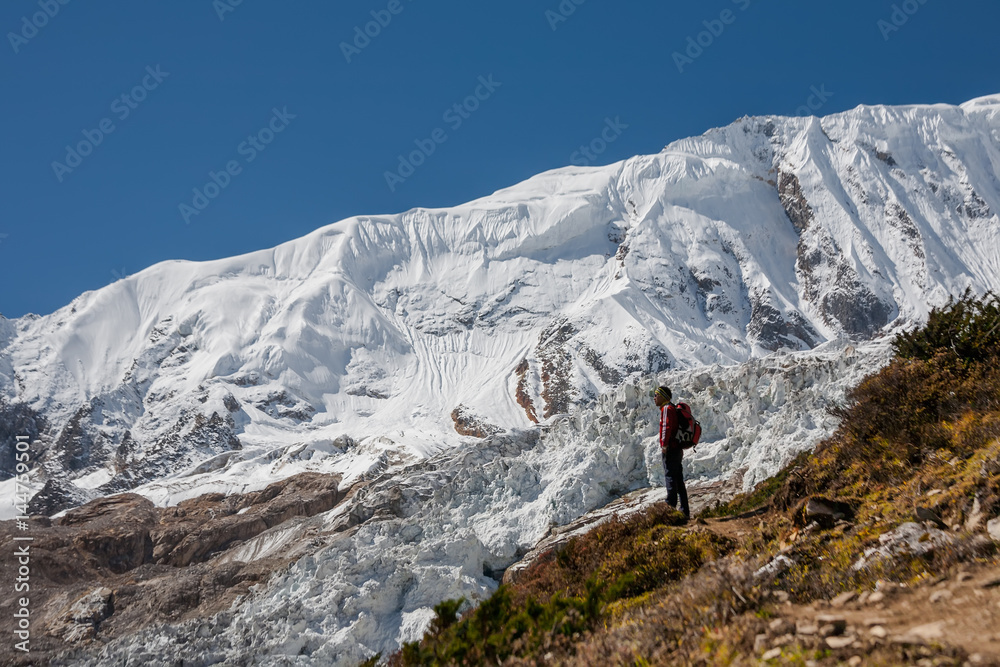 Trekker in front of Manaslu glacier on Manaslu circuit trek in Nepal