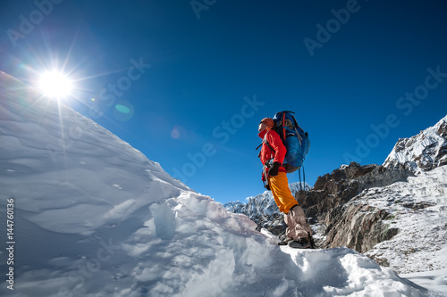Trekker looks at the sun while crossing Cho La pass in Everest region, Nepal