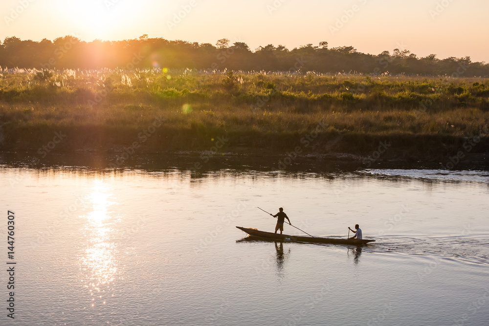 Naklejka premium November 17, 2013 - men are fishing on Rapti river at the border of Chitwan national park, Nepal