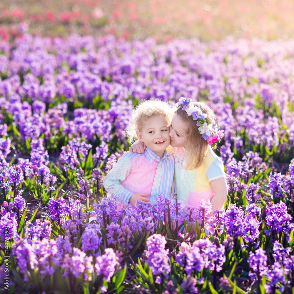 Kids playing in blooming garden with hyacinth flowers Kids playing in blooming garden with hyacinth flowers