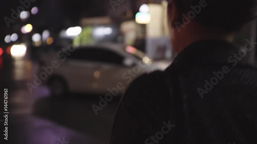 woman walking alone in urban night
