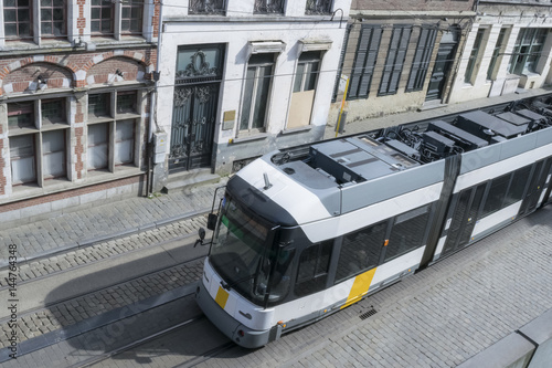 Modern tram car and the medieval houses in the city of Ghent, Belgium.  View from the wall of the Gravensteen castle.